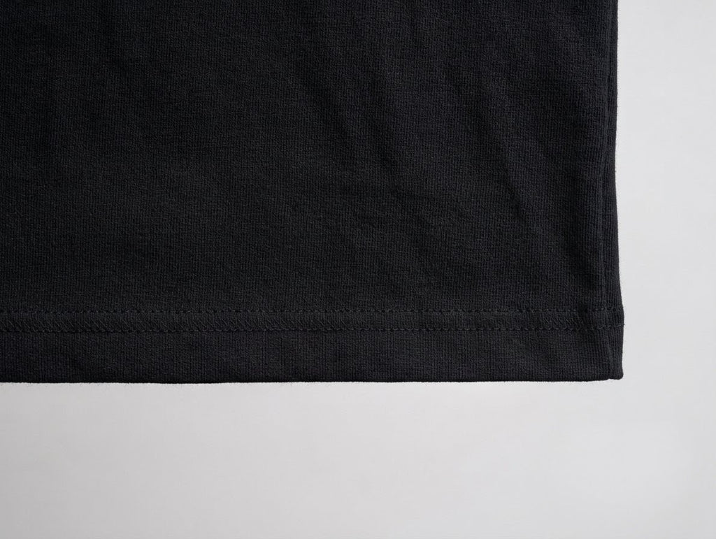 Close-up of a black fabric edge on a light gray background